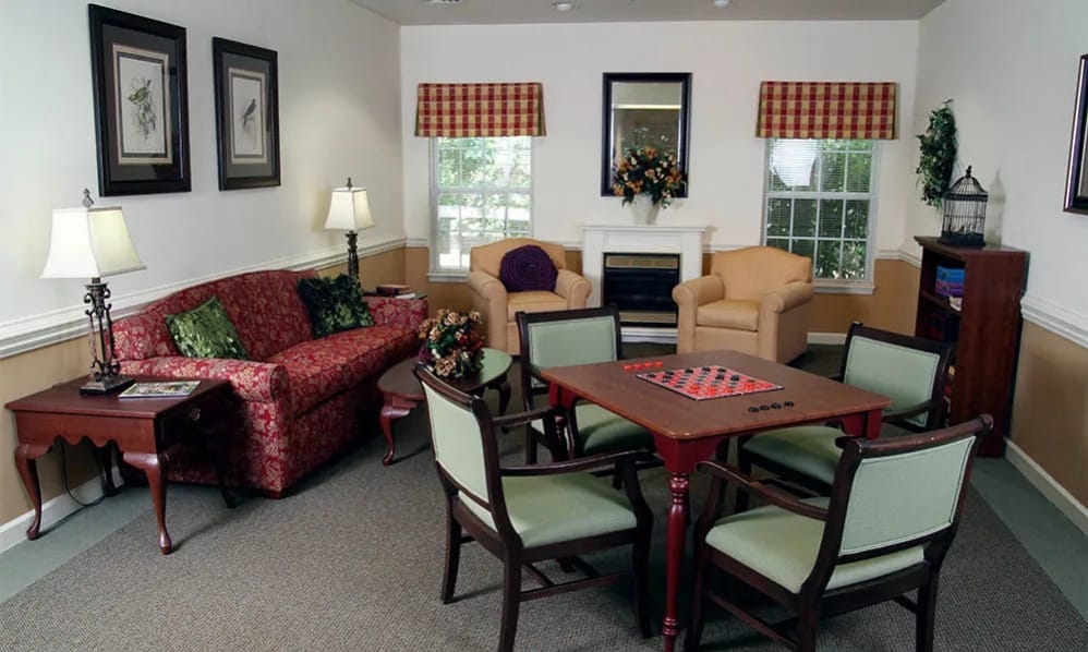 Living room with seating, a fireplace, and a game table