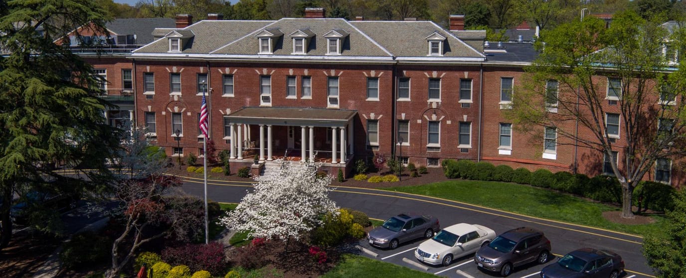 Aerial view of a senior living facility with gardens