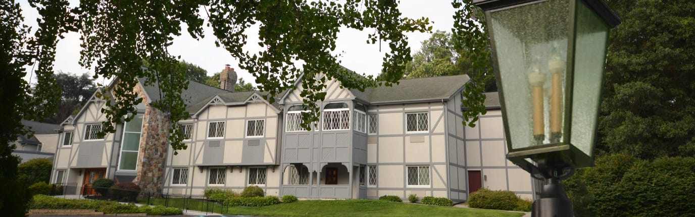 Exterior view of Ivy Gables Senior Living facility surrounded by greenery