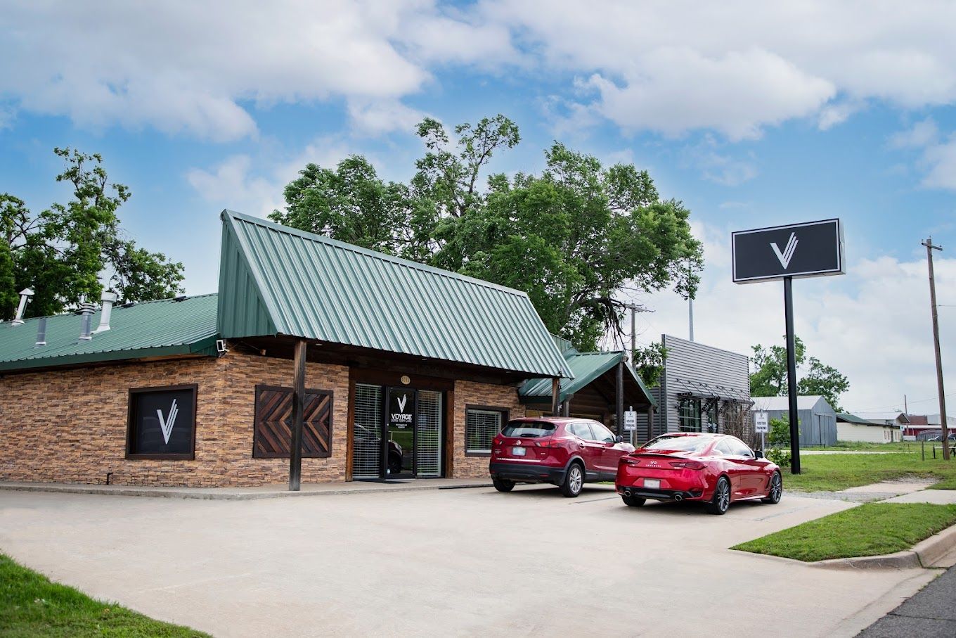 Exterior view of the facility building with vehicles
