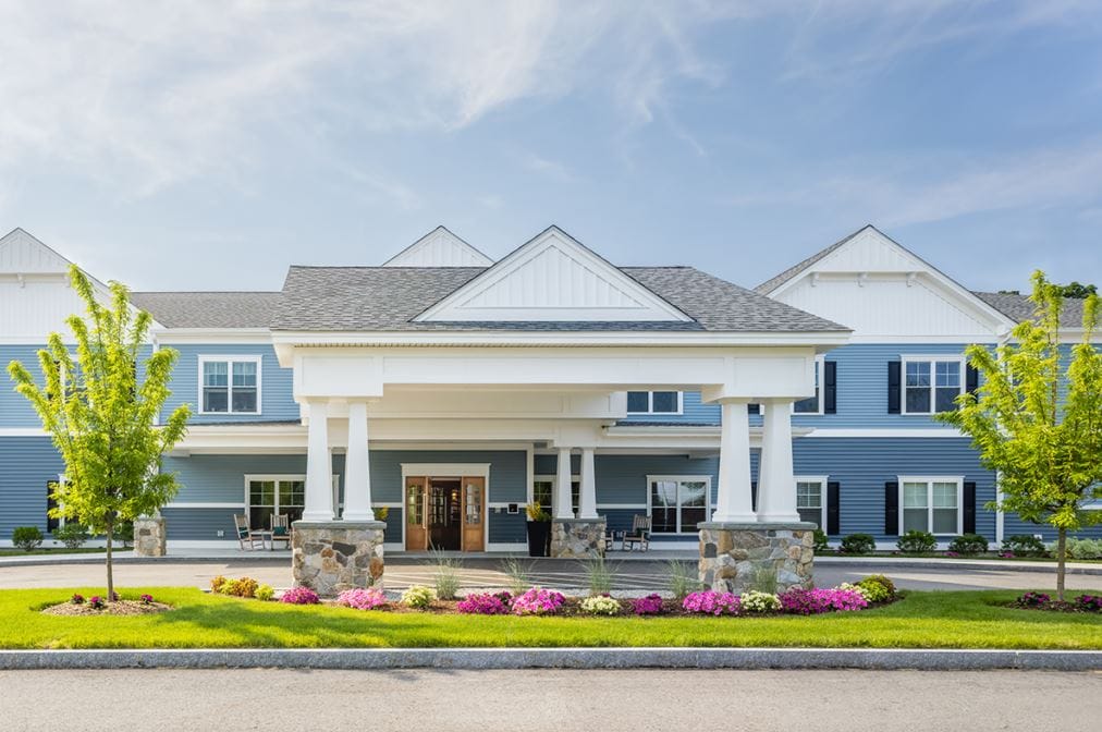 Exterior view of a senior living facility with flowers