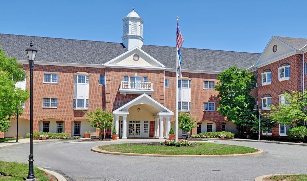 Exterior view of a senior living facility with landscaping