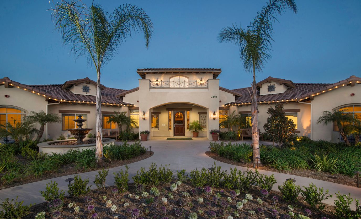 Exterior view of a senior living facility at dusk