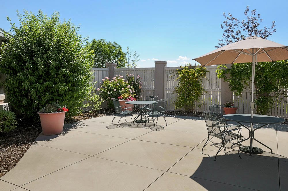 Outdoor patio area with tables and plants