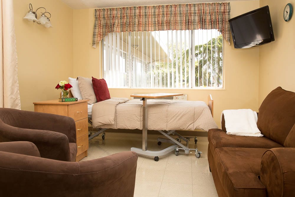 Interior view of a resident room with furnishings and window