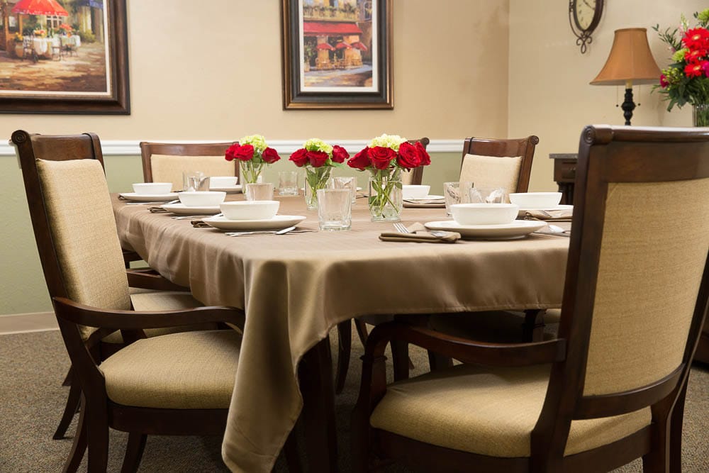 Dining table set for a meal with flowers