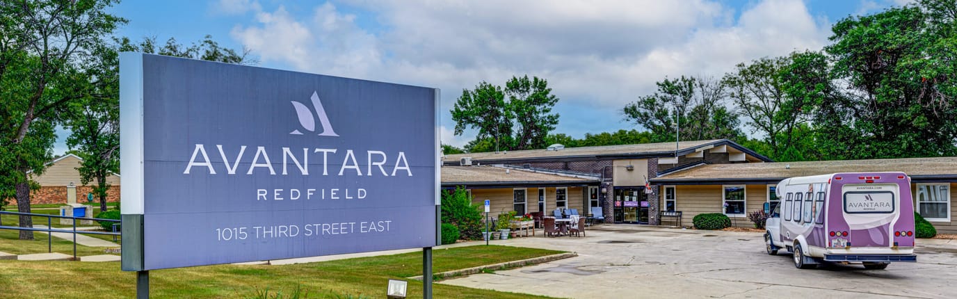 Exterior view of Avantara Redfield facility with transport van