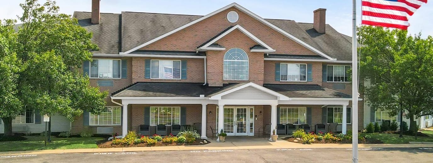 Exterior view of a senior living facility with landscaping