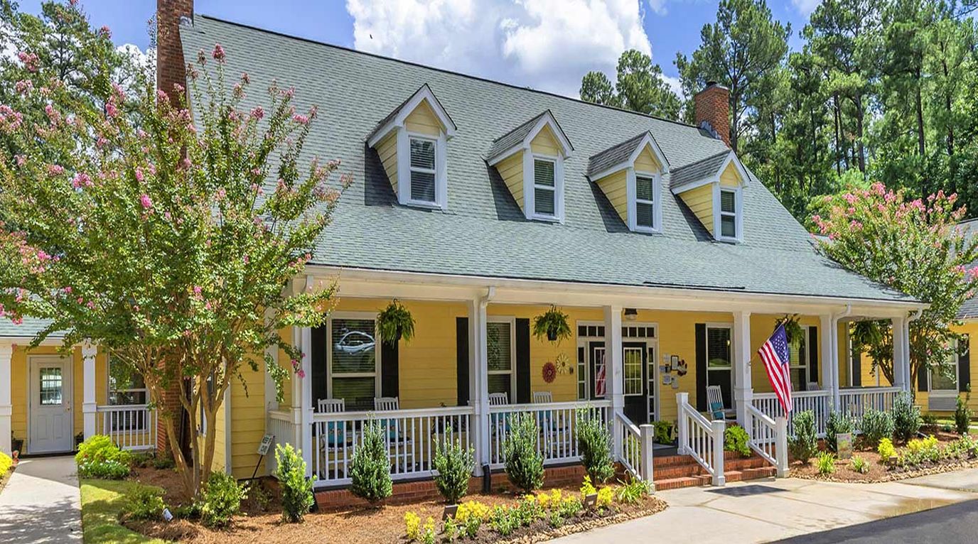 Exterior view of a senior living facility with gardens