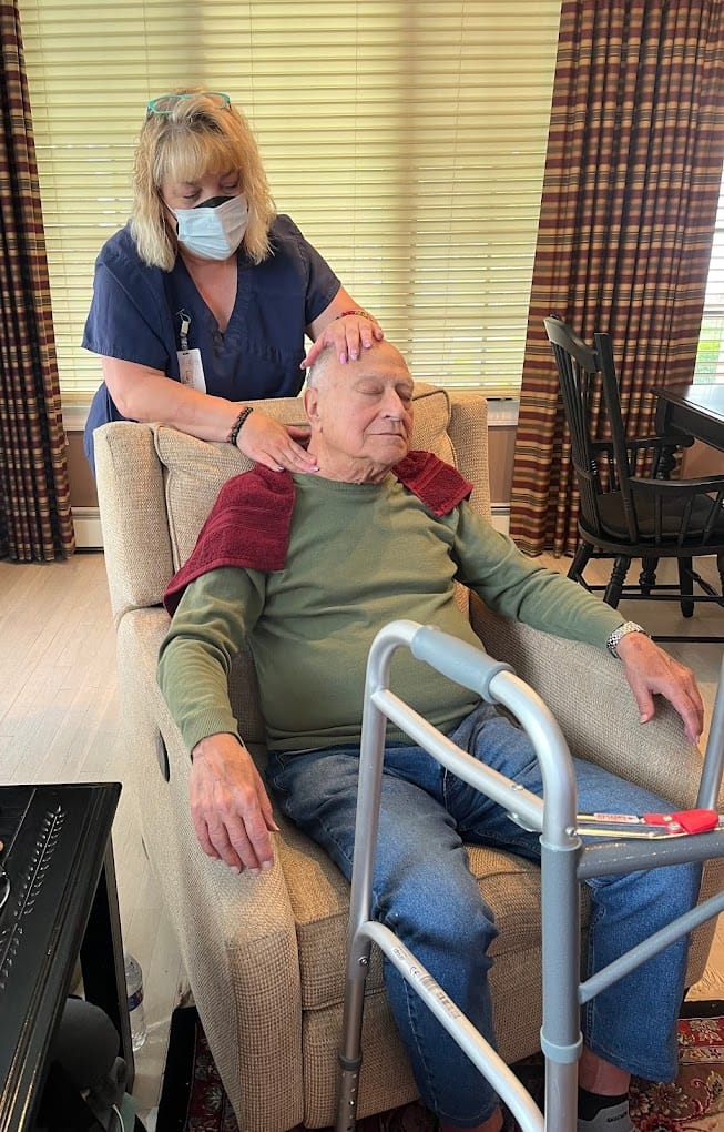 Staff member providing care to a resident in a common area