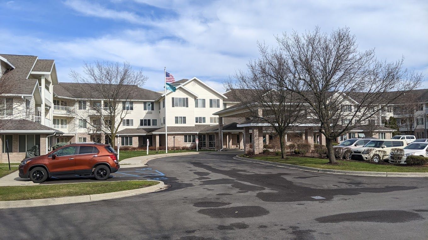 Exterior view of Holiday Genesee Gardens with parking area
