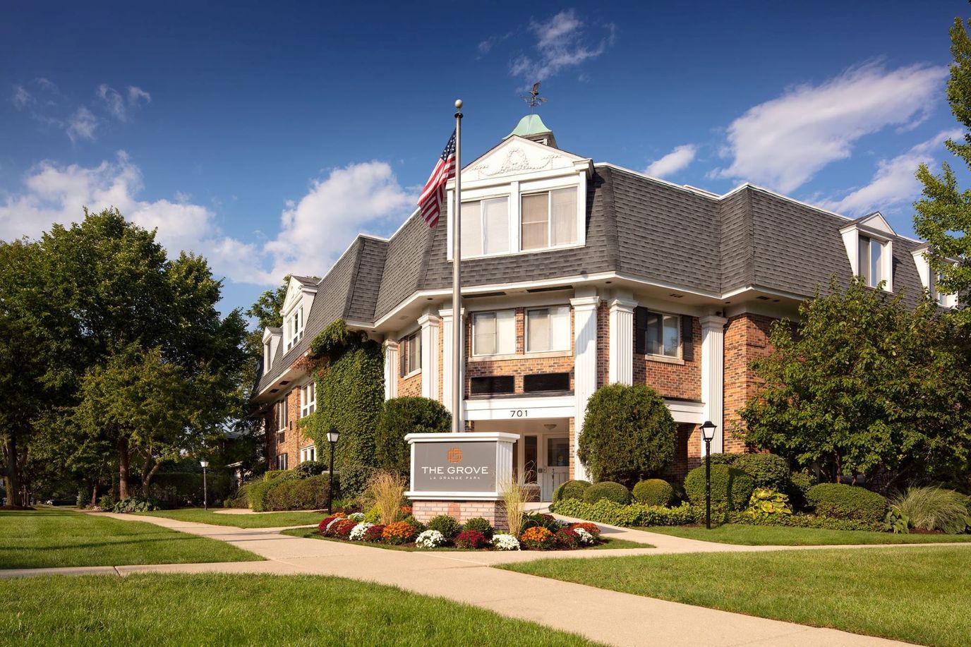 Exterior view of The Grove facility with landscaping