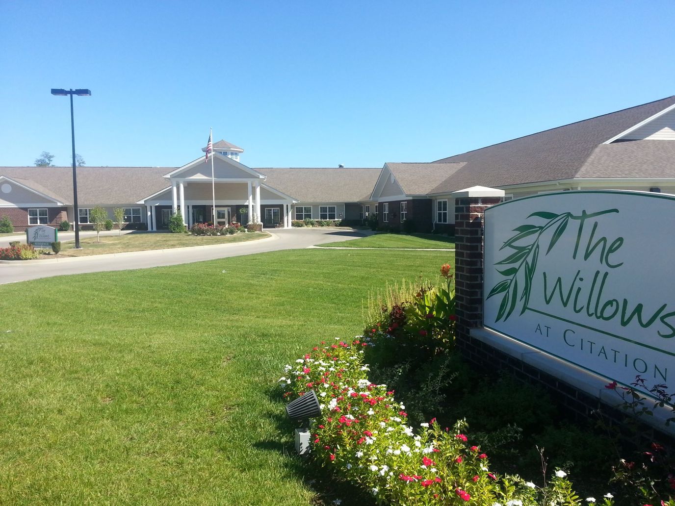 Exterior view of The Willows at Citation with garden
