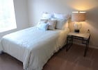 Cottage Grove Place, Nursing Home in Cedar Rapids, IA — Cozy bedroom with a bed and bedside lamp