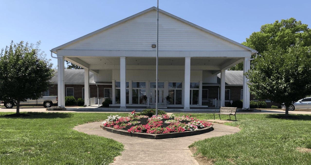 Exterior view of The Wyndmoor of Evansville with flowers