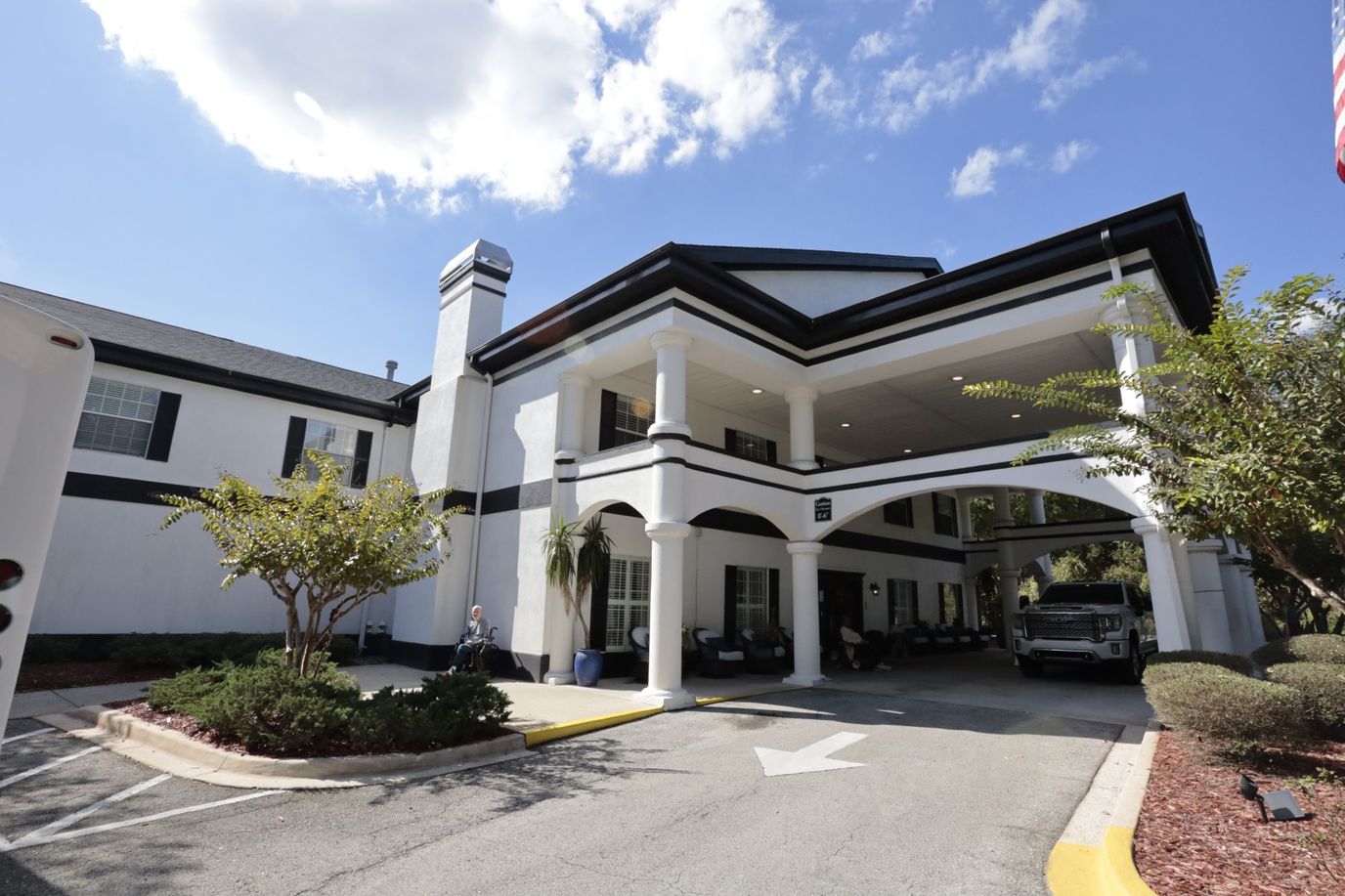 Front entrance of a senior living facility with a covered area