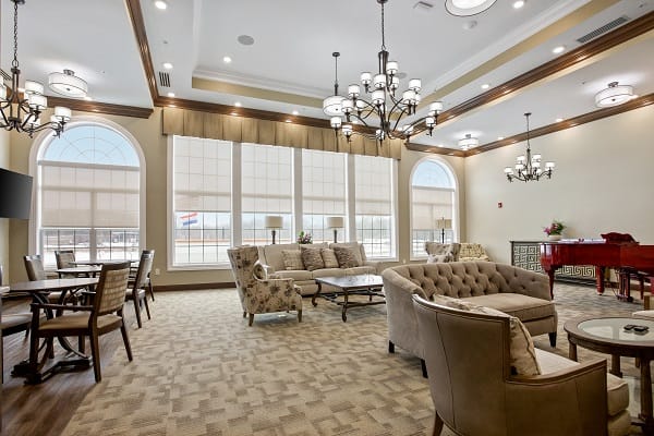 A cozy common area with seating and large windows