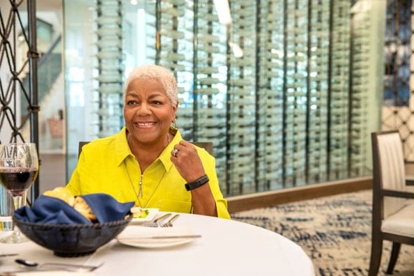 A woman enjoying a meal in the dining room