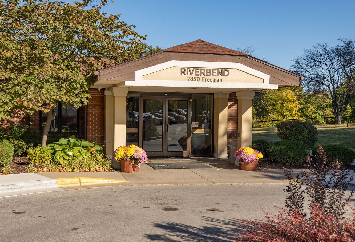 Entrance of the Riverbend facility with landscaped flowers