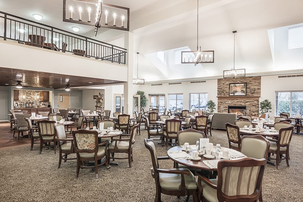 Dining area with tables and chairs in a bright interior.