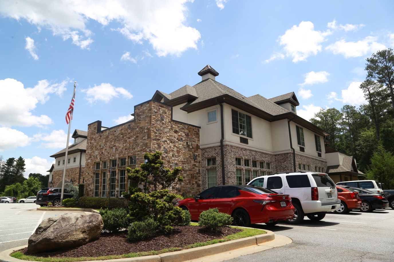 Exterior view of Orchard Senior Living facility with vehicles