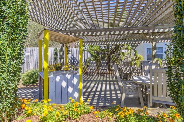 Outdoor shaded seating area with flowers