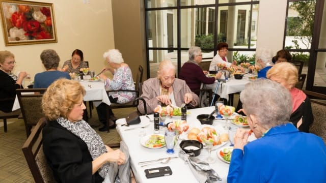 Residents enjoying a meal in the dining area.
