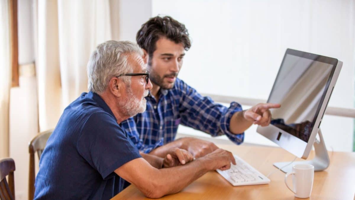 Older adult receiving assistance with technology