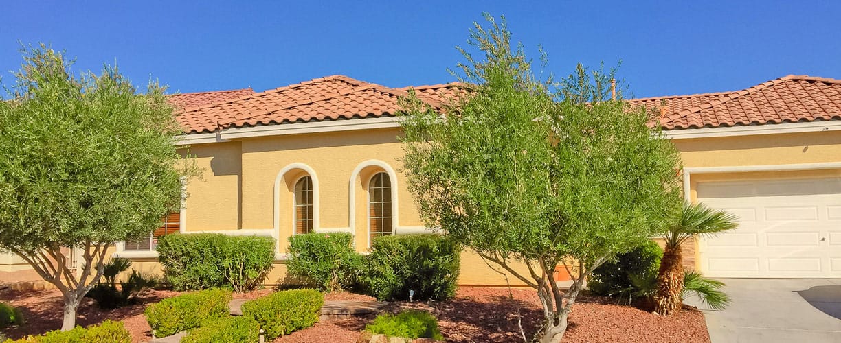 Exterior view of a senior living building with landscaping