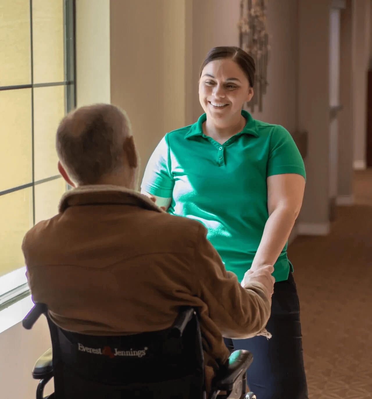 Staff member engaging with a resident in a corridor