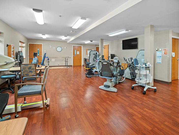 Good Samaritan Society Sioux Falls Center, nursing home in Sioux Falls, SD — Exercise equipment in a spacious rehabilitation room