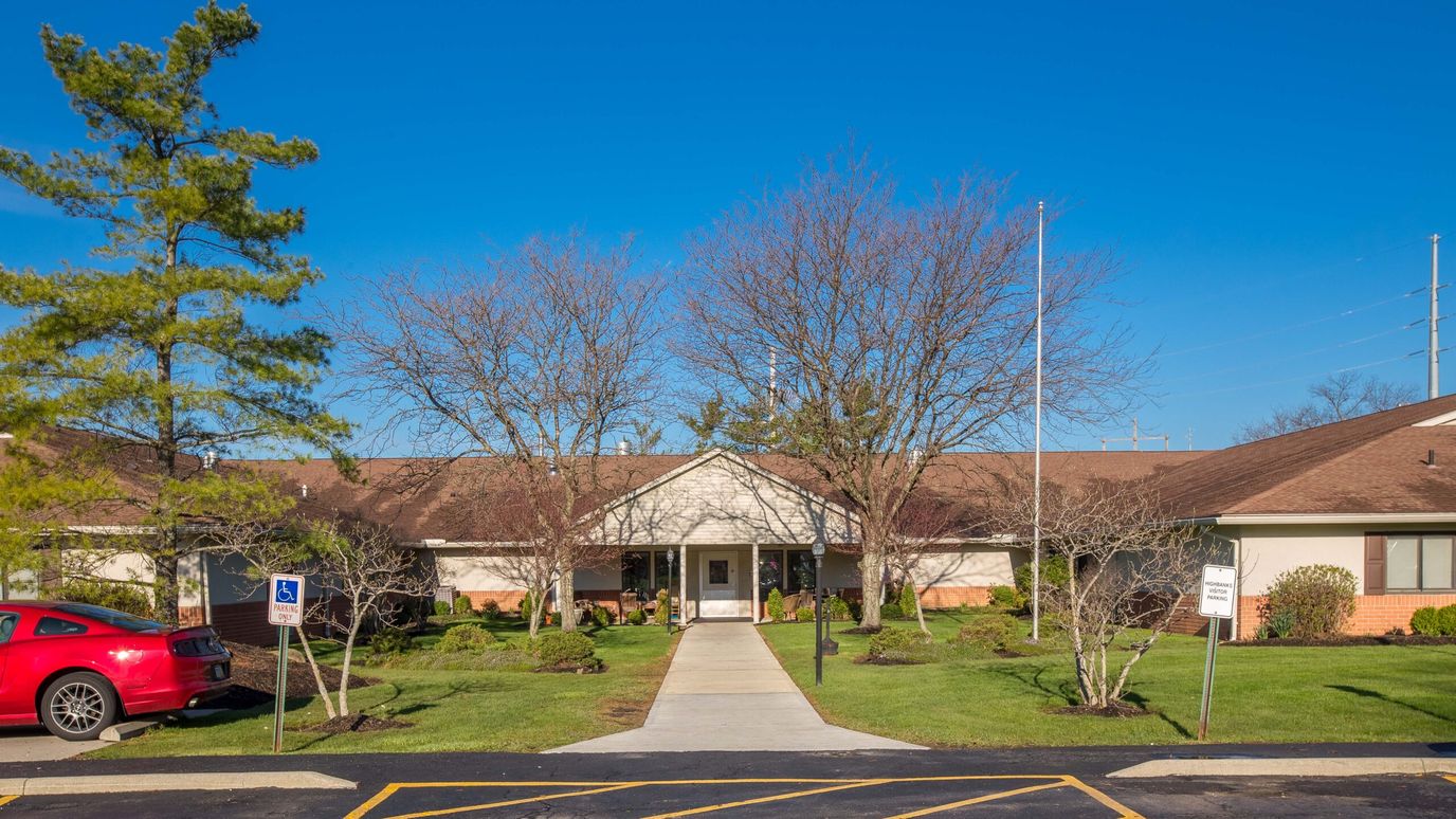 Exterior view of Highbanks Care Center with landscaped entrance