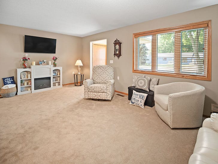 A cozy common area with seating and TV