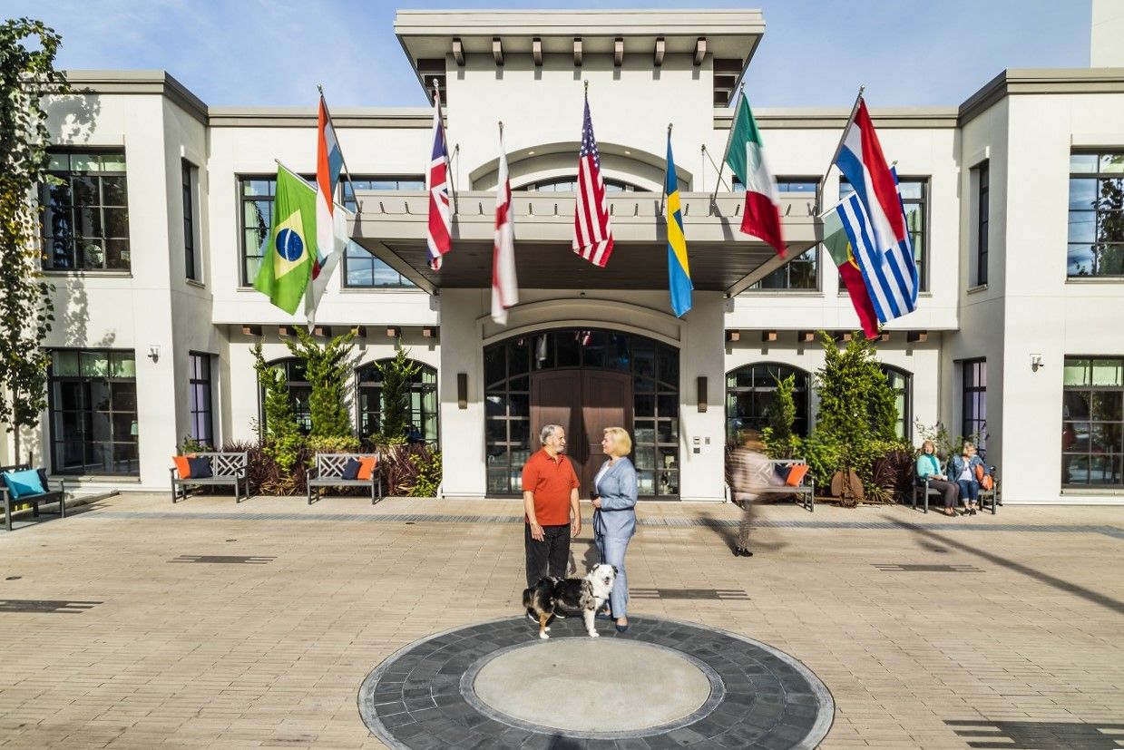 Residents standing in front of facility with flags