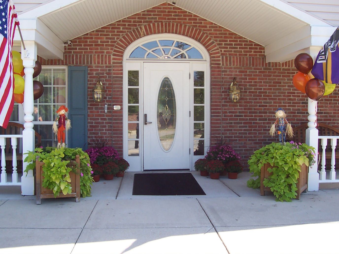 Front entrance with seasonal decorations and plants