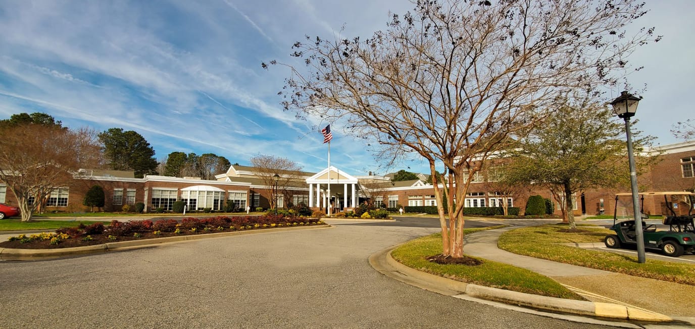 Exterior view of a senior living facility with landscaping