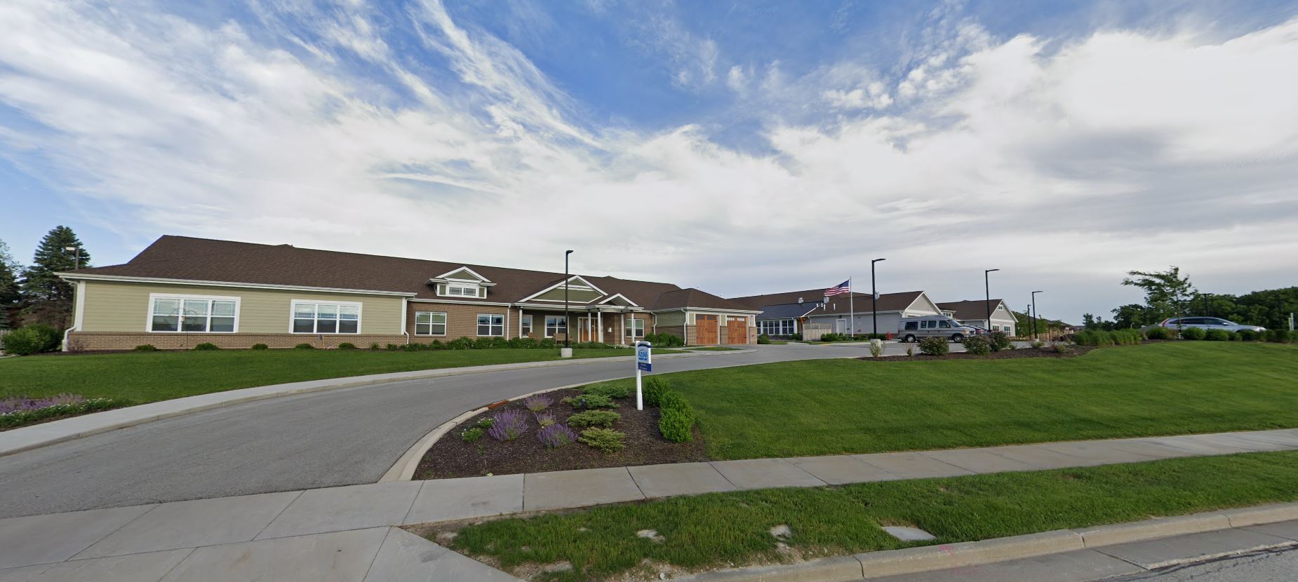 Exterior view of a senior living facility with green landscaping