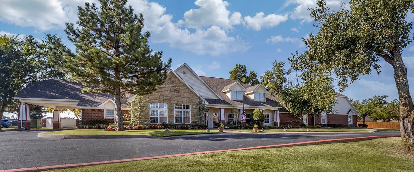 Exterior view of a senior living facility with landscaping