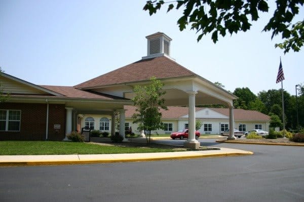 Front entrance of a senior living facility with a covered entrance