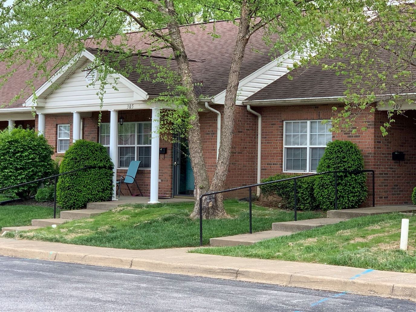 Exterior view of a residential unit with landscaping
