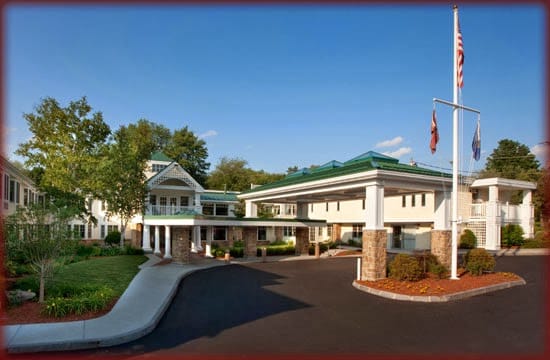 Exterior view of a senior living facility with gardens