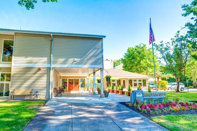Exterior view of Junction City Retirement facility with flowers