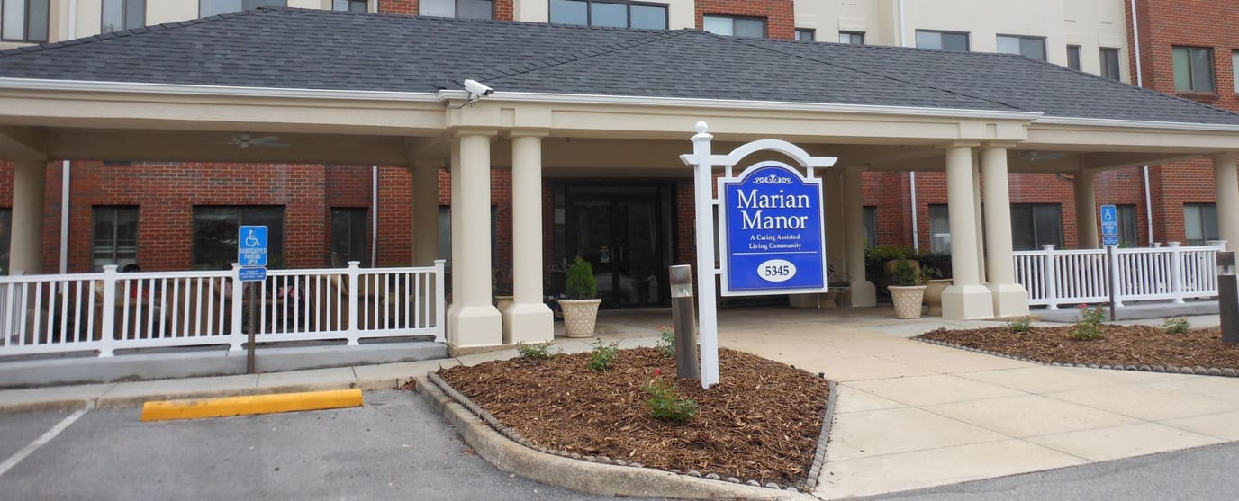 Exterior view of Marian Manor with signage and landscaping