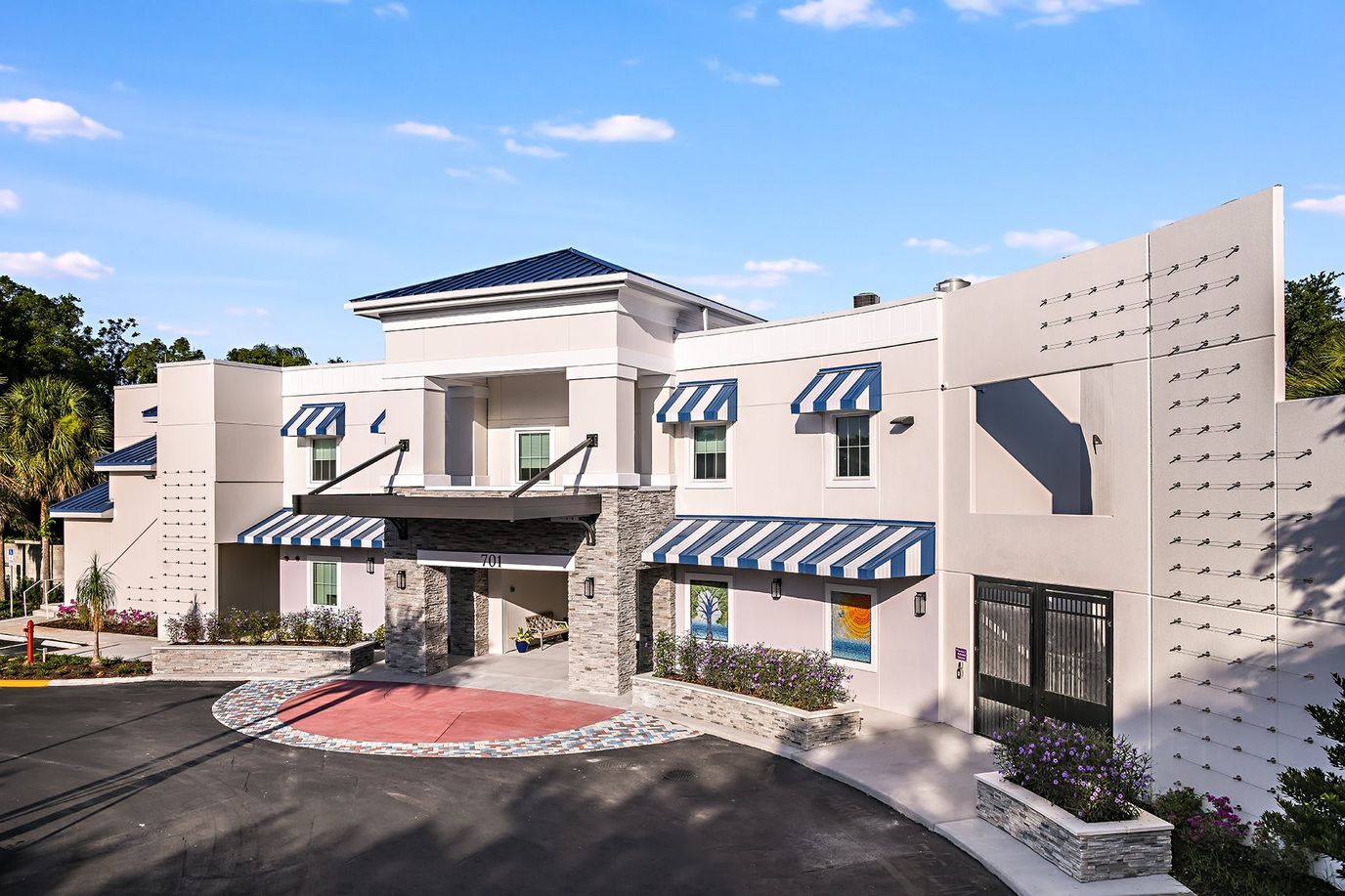 Exterior view of a senior living facility with awnings