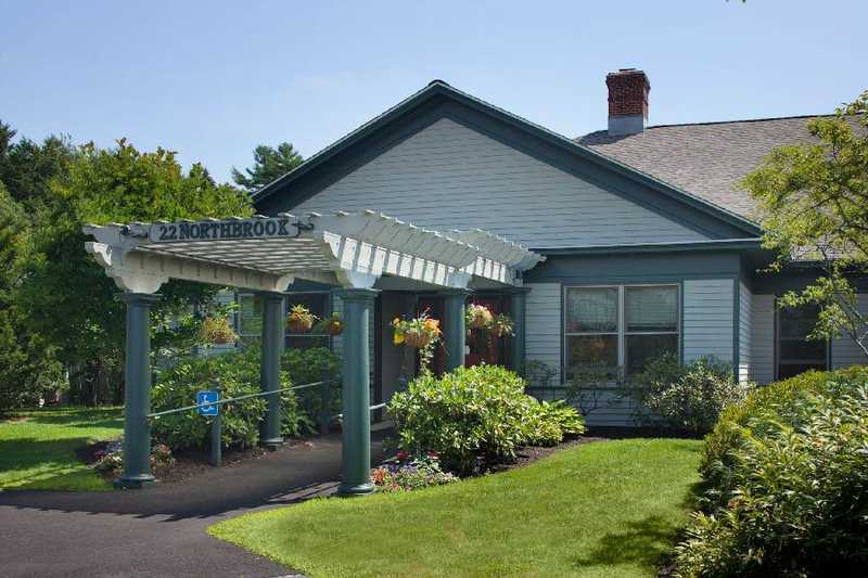 Exterior view of a facility entrance with garden and porch