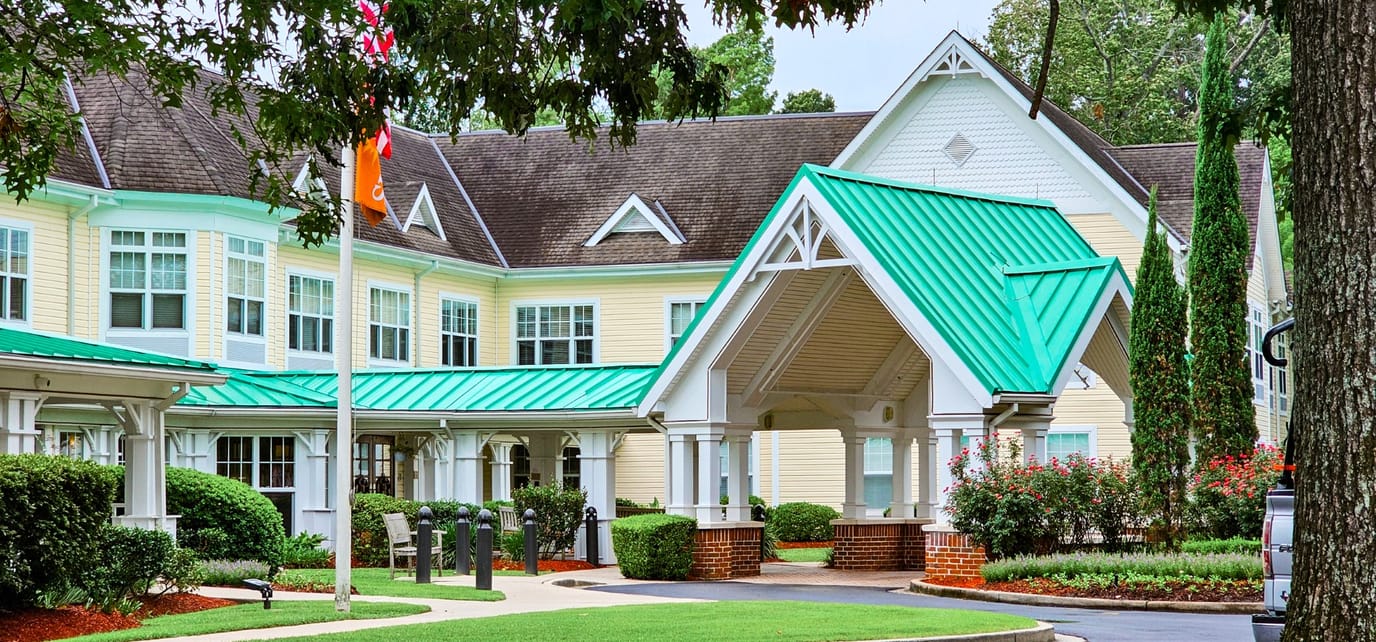 Exterior view of a senior living facility with a green roof