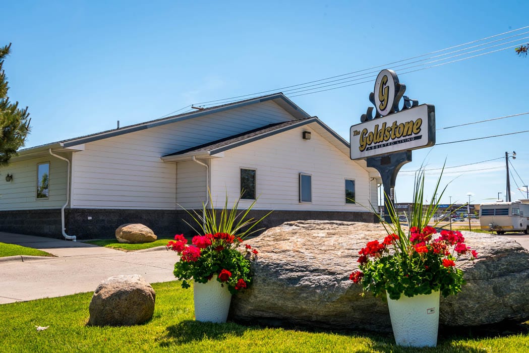 Outdoor view of The Goldstone Assisted Living sign