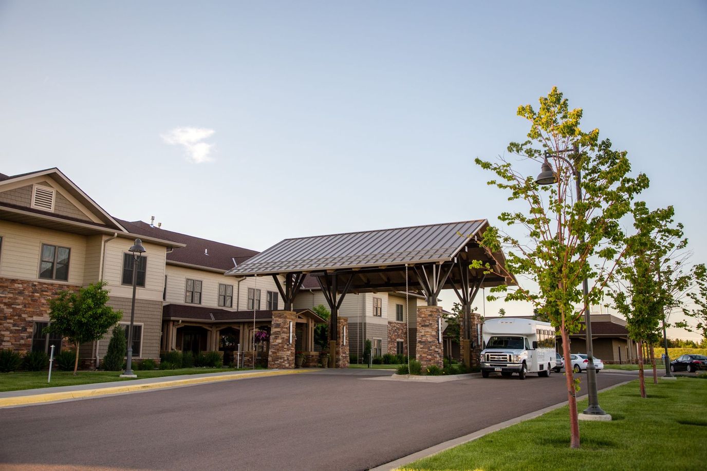 Exterior view of the facility entrance with walkways and trees