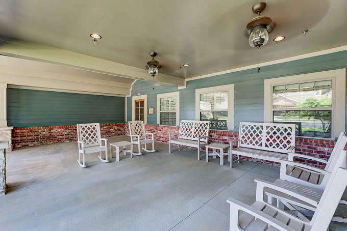 Spacious outdoor patio with white seating and blue walls