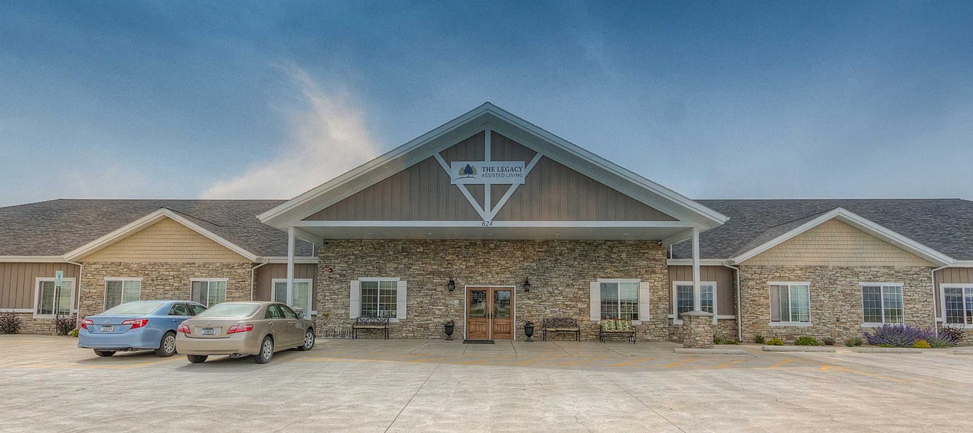 Front entrance of The Legacy facility with cars parked outside